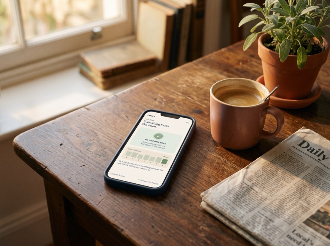 A phone face up on a kitchen table beside a coffee cup, showing a calm day